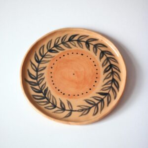 A beautifully crafted ceramic plate featuring a delicate leaf design.